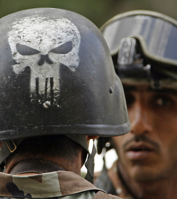 Iraqi soldier wearing a helmet with the Punisher skull painted on the back