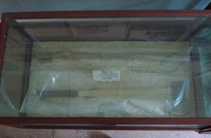 Two axes, wrapped in plastic bags, on display
