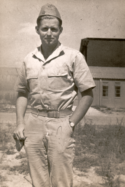 Joseph P. Kennedy Jr. standing in his US Navy uniform
