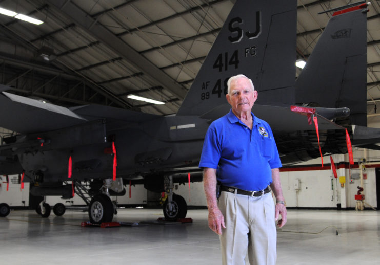 John "Bob" Pardo standing in front of a McDonnell Douglas F-15E Strike Eagle parked inside a hangar