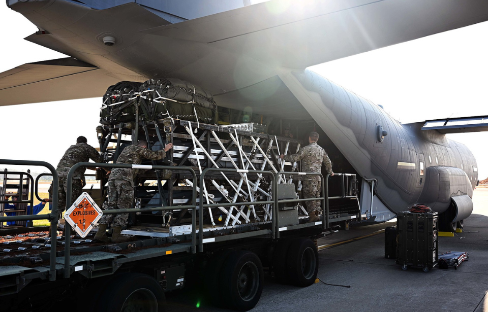 Airmen with 1st Special Operations Logistics Readiness Squadron loading a Rapid Dragon Palletized Weapon System onto a Lockheed MC-130J