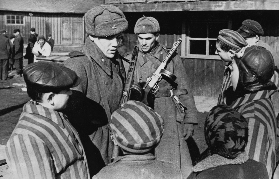 Red Army soldiers speaking to child prisoners at Auschwitz