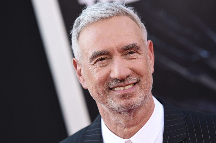 Roland Emmerich posing on a red carpet