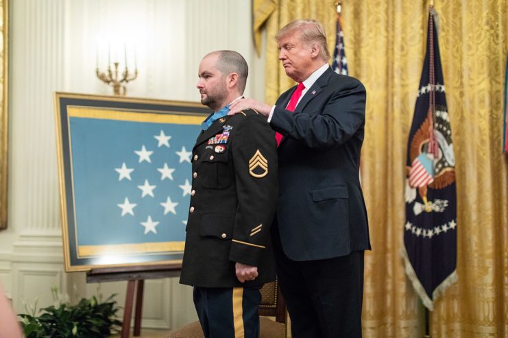 US President Donal Trump placing the Medal of Honor around Staff Sgt. Ronald J Shurer II's neck