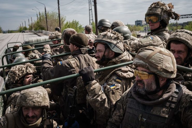 Ukrainian soldiers riding in the back of a truck