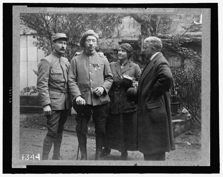Anna Coleman Ladd standing with two soldiers and a third man