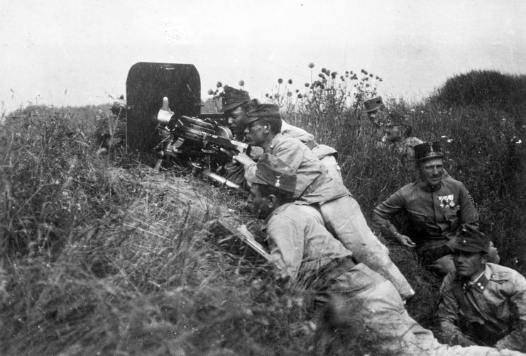 Four soldiers manning a Schwarzlose MG, with four others lying behind them