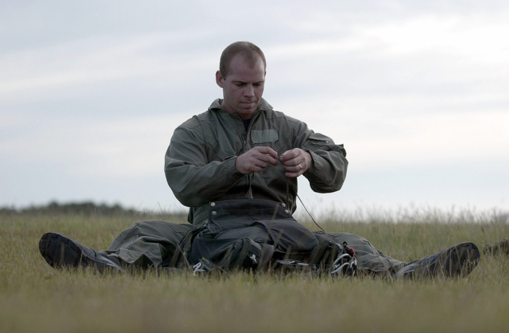 US Navy SEAL Mike Day preparing his parachute in a grassy field
