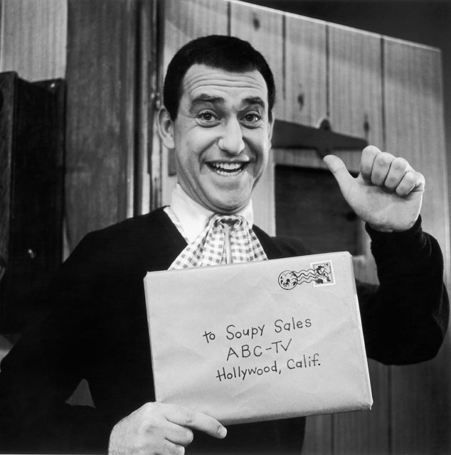 Soupy Sales holding up a letter addressed to him
