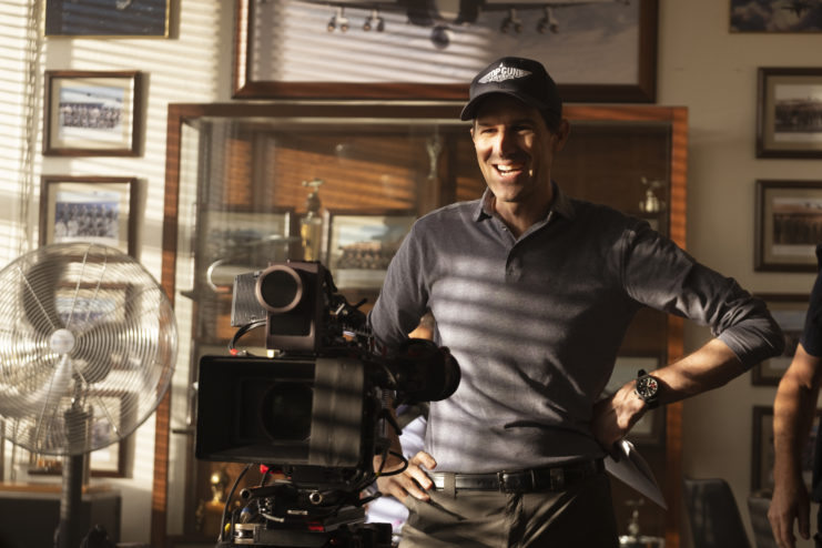 Joseph Kosinski standing behind a camera