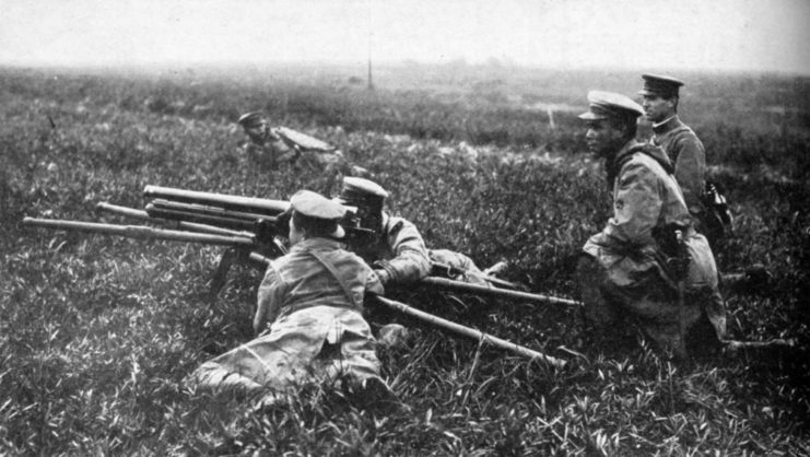 Four Imperial Japanese Army soldiers manning a Type 11 37 mm infantry support gun