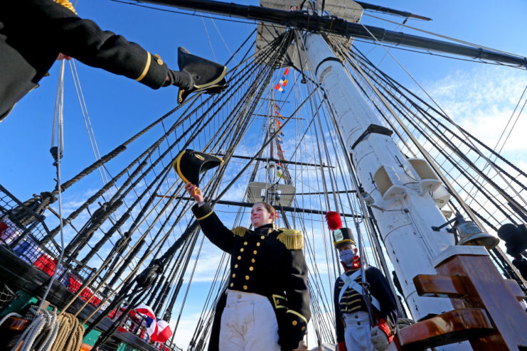 Billie Farrell standing with other naval personnel aboard the USS Constitution