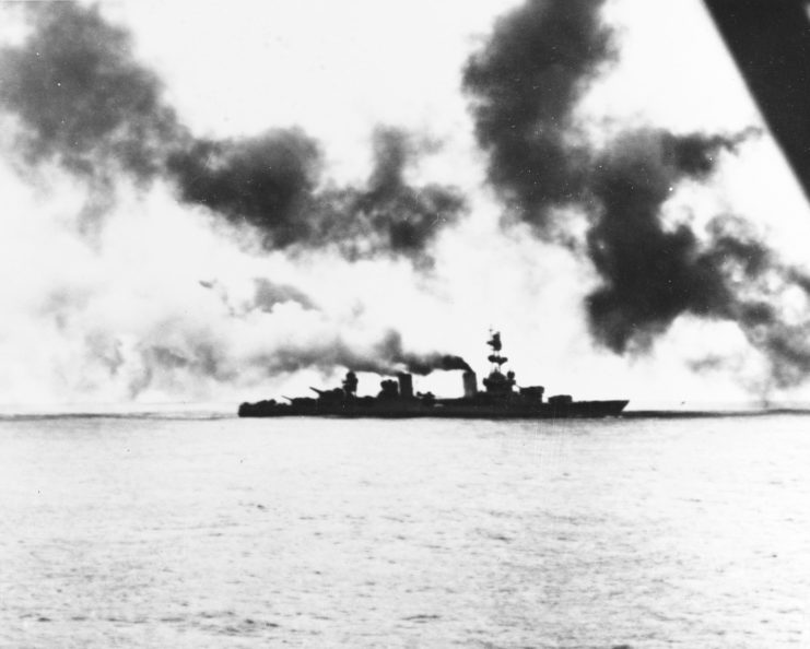 USS Salt Lake City (CA-25) at sea, with smoke rising from her