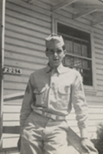 William 'Wild Bill' Guarnere standing outside in his military uniform