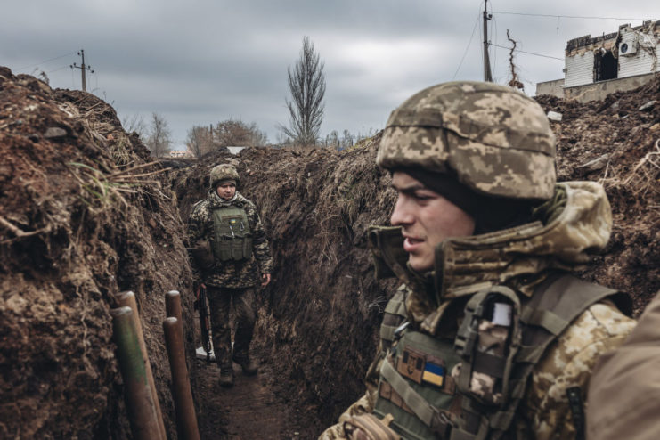 Two Ukrainian soldiers standing in a trench