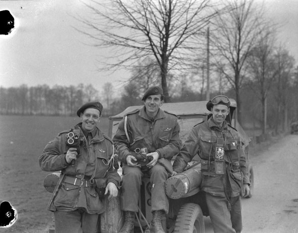 Three members of the Canadian Army Film and Photo Unit standing together