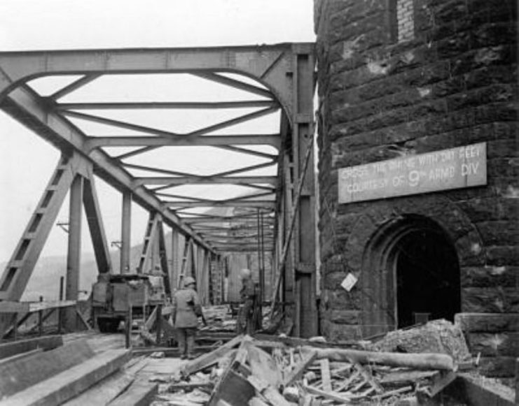 US soldiers standing among rubble on Ludendorff Bridge