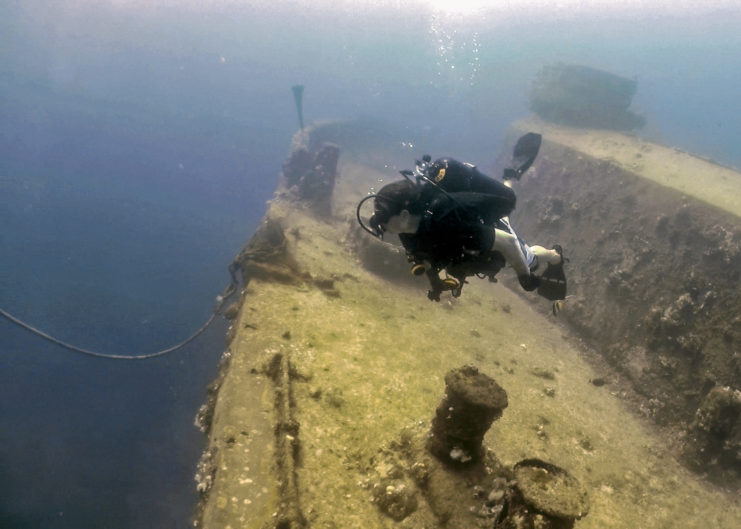 Sean Ratz swimming around a sunken barge