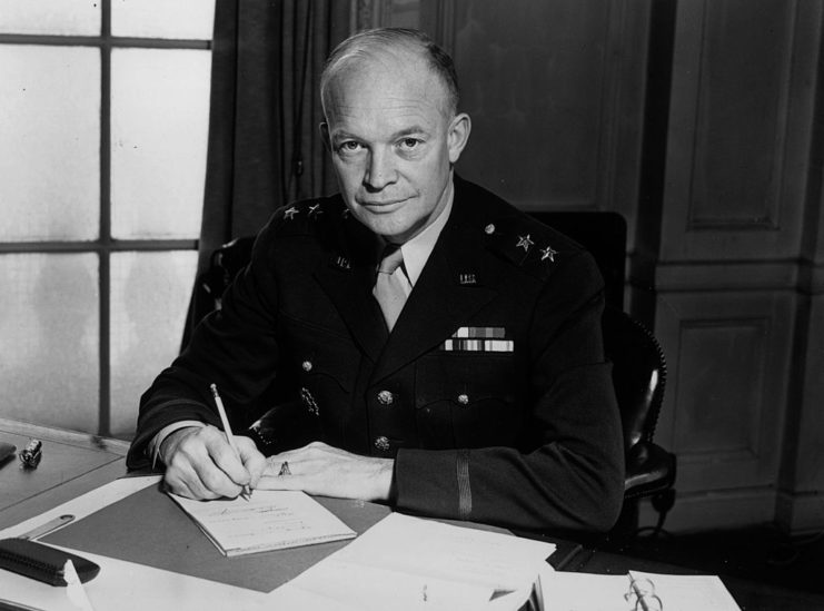 Dwight D. Eisenhower writing a note at his desk