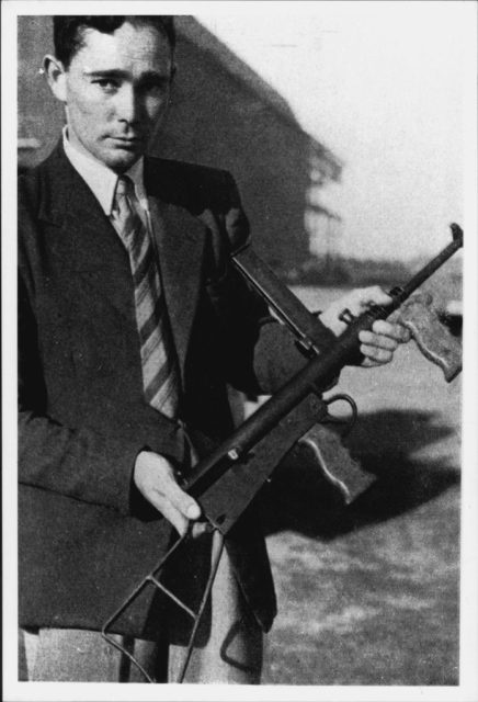 Evelyn Owen holding an Owen gun
