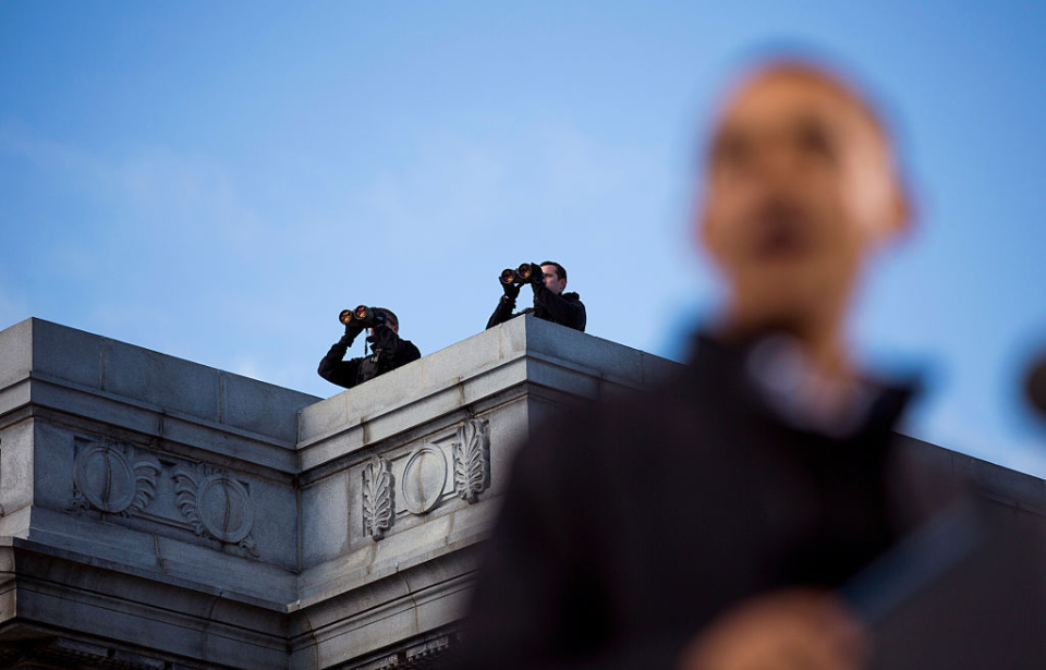Two Secret Service snipers keeping watch over US President Barack Obama from a rooftop