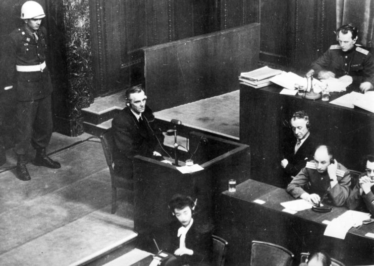 Friedrich Paulus sitting in a courtroom with a number of other individuals