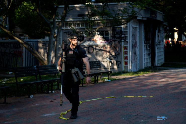 Secret Service sniper walking along a path