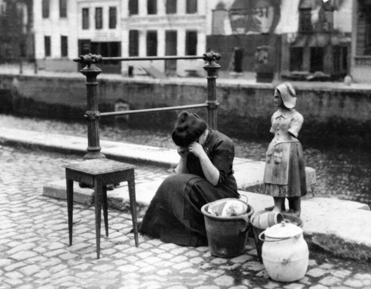 Woman crying while sitting on the side of a road