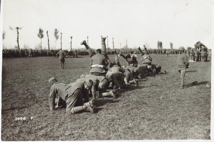 Italian soldiers kneeling together in the grass
