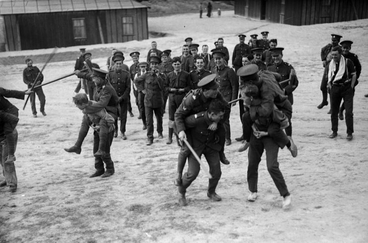 South African soldiers running around with their comrades on their backs