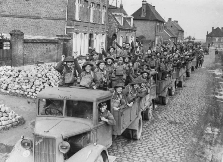 Convoy of British soldiers driving down a street