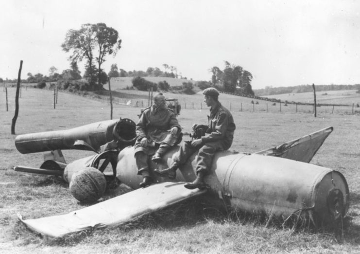 Two Canadian soldiers sitting atop a V-1 "buzz bomb"