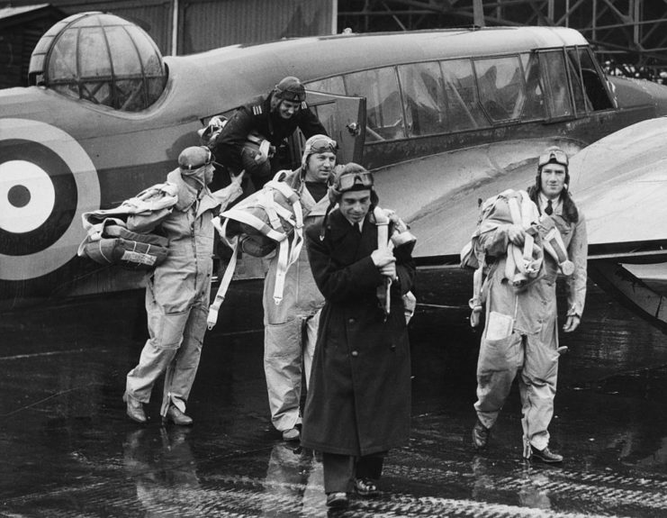 Five Air Transport Auxiliary (ATA) pilots walking away from an aircraft