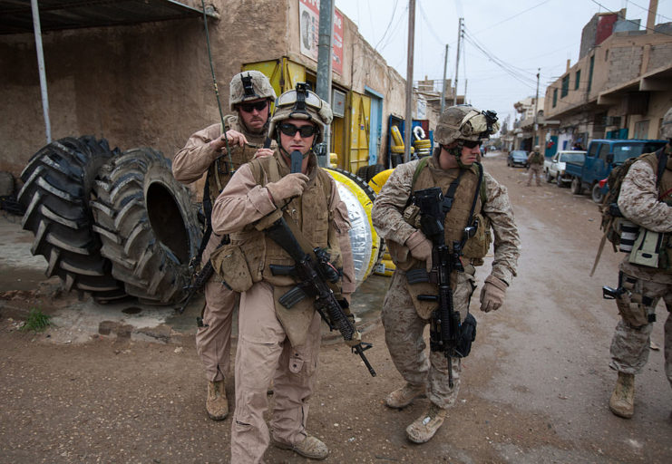 US Marines standing in the middle of a downtown street in Iraq