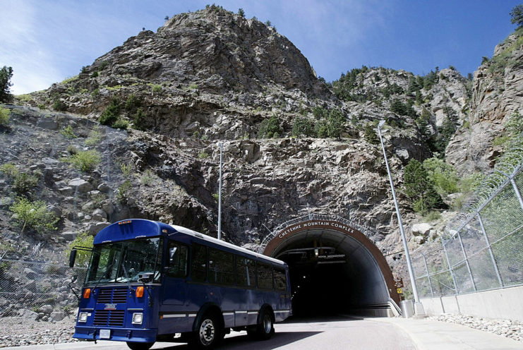Shuttle bus driving away from the entrance tunnel to the Cheyenne Mountain Complex