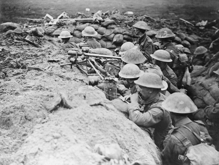 Soldiers aiming their weapons while standing in a trench