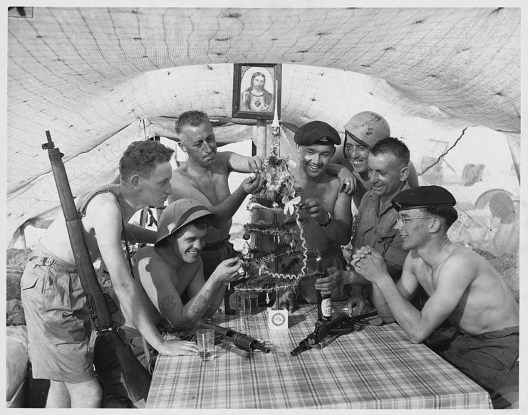 Peter Gallagher, John Dean, Jim Read, Jack Allen, Jim Highton, Manuel Armario and Reg Bomson decorating a Christmas tree