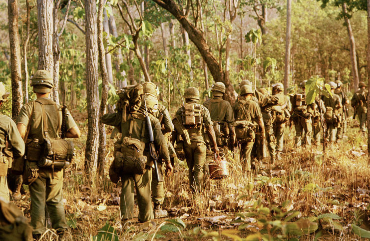 American troops walking through the Vietnamese jungle