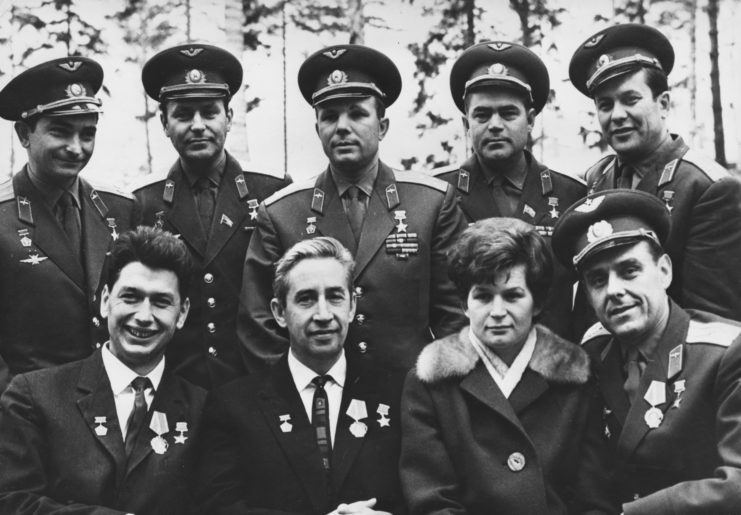 Eight cosmonauts standing together with a woman