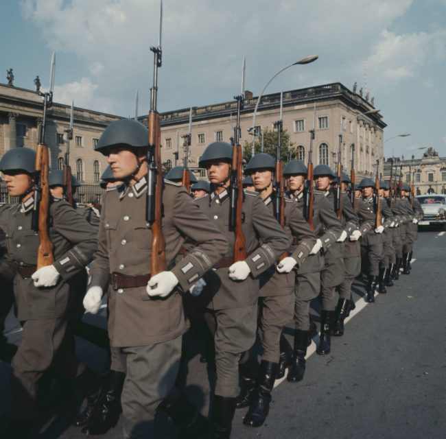 East German soldiers marching together while armed with Gewehr 43s