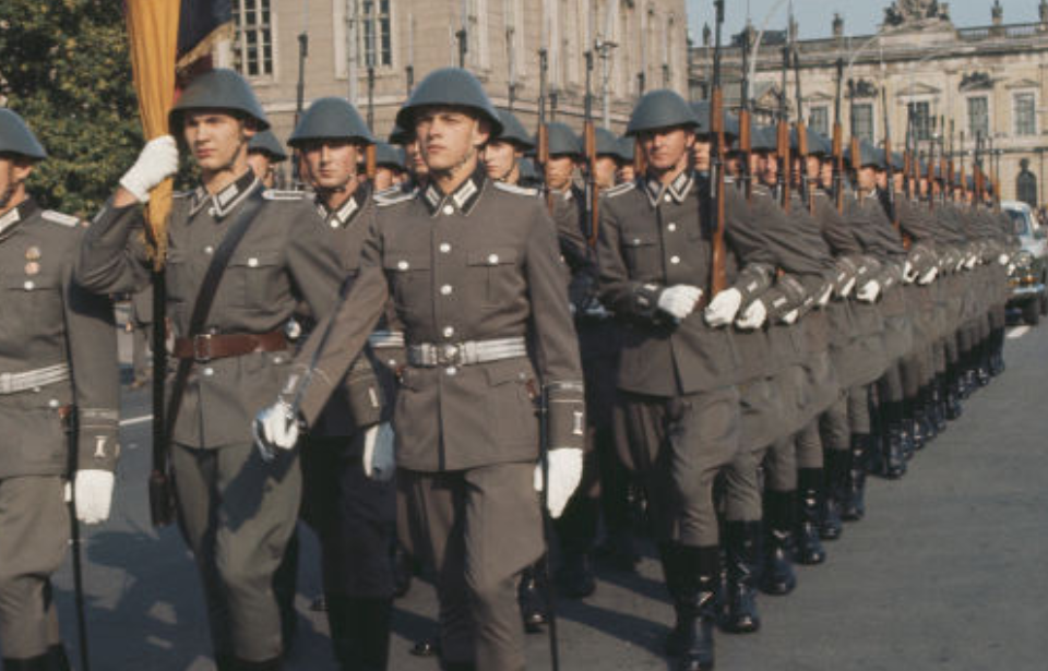 East German soldiers marching together while armed with Gewehr 43s