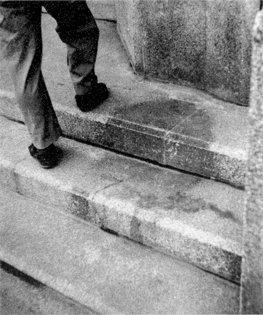 Human shadow on the steps at the entrance of the Hiroshima branch of Sumitomo Bank