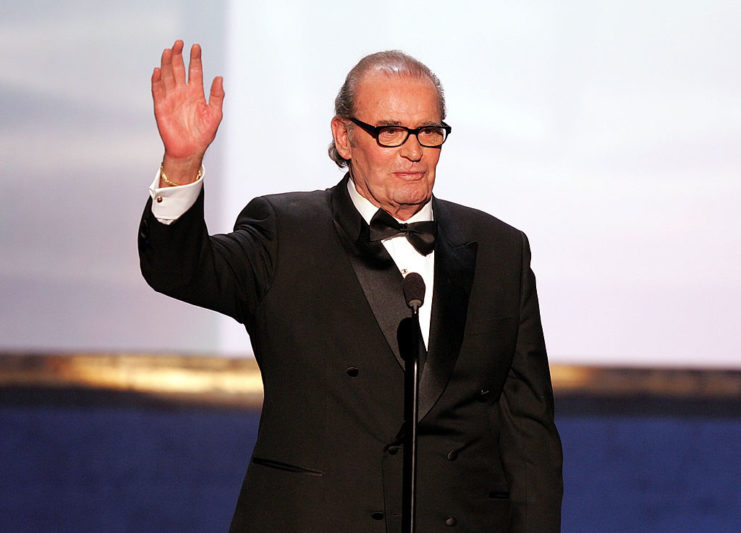 James Garner speaking at a microphone