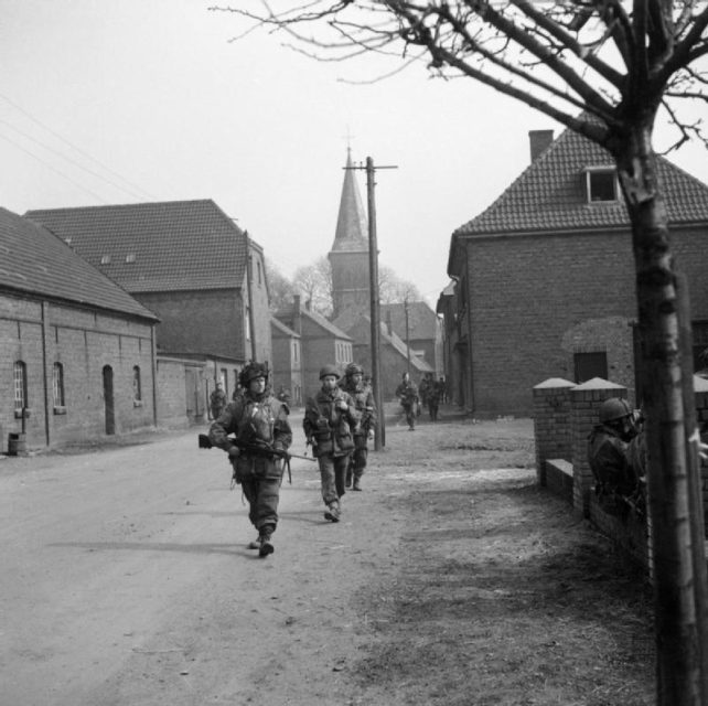 British paratroopers walking down a street in Hamminkeln, Germany