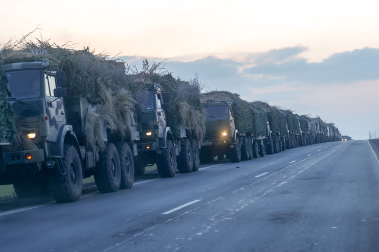 Military convoy driving down a road