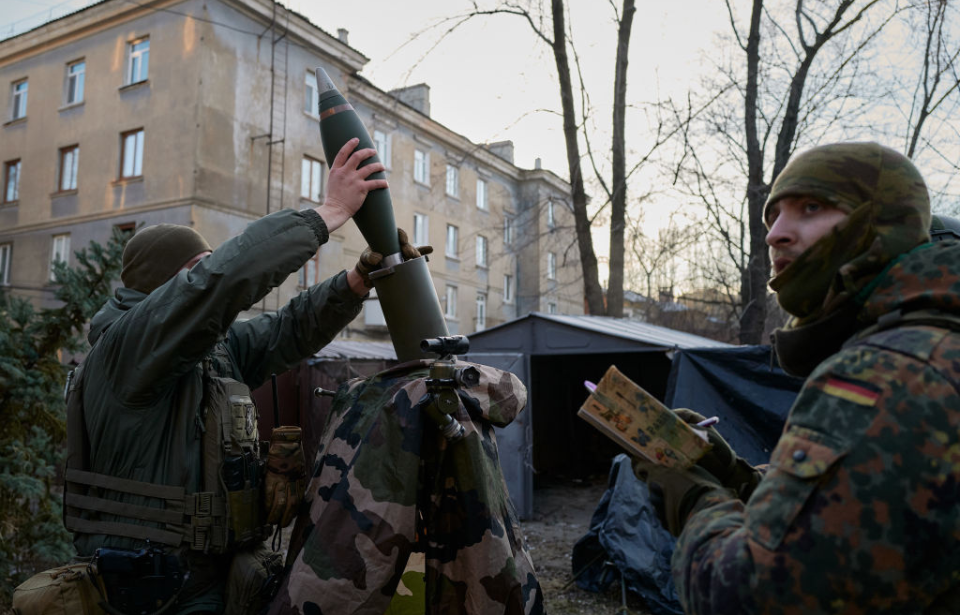 Ukrainian Special Forces members loading fire mortar shells