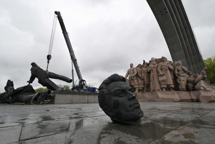 Machinery taking apart a Soviet-era monument in Kyiv