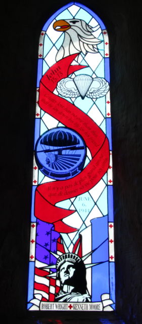 Stained glass window featuring the 101st Airborne Division's insignia and the Statue of Liberty