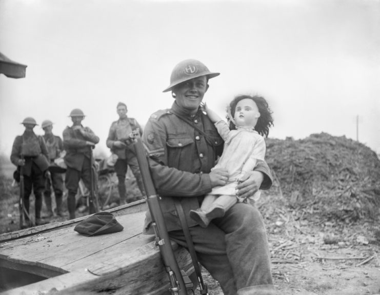 British "Tommy" holding a doll