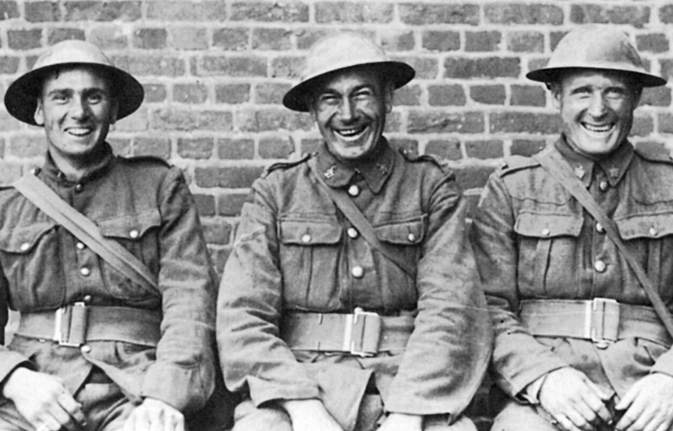 Three British "Tommies" sitting together in uniform